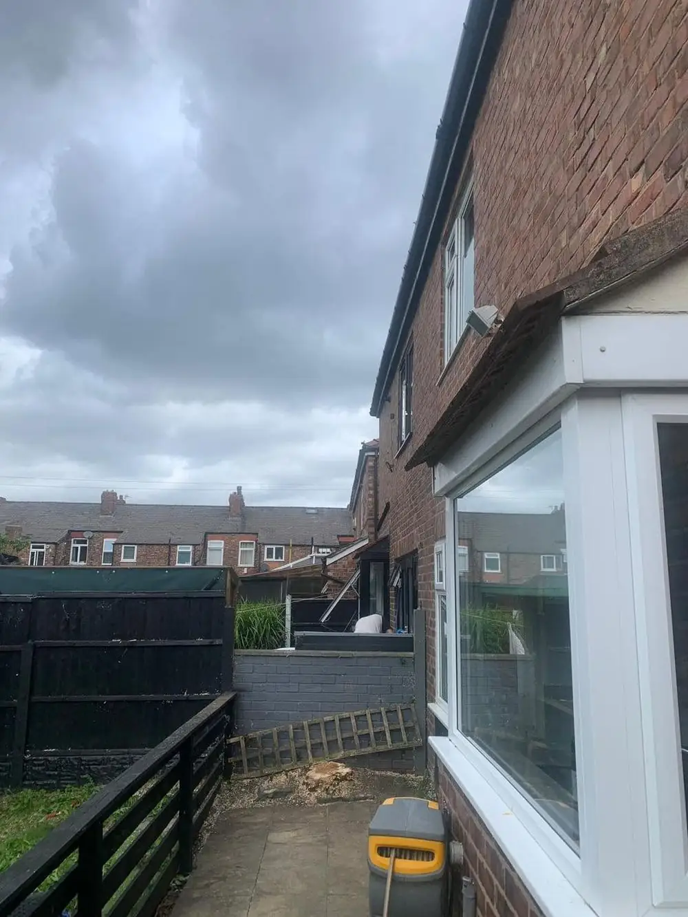The side of the house with the tree removed and the path clear