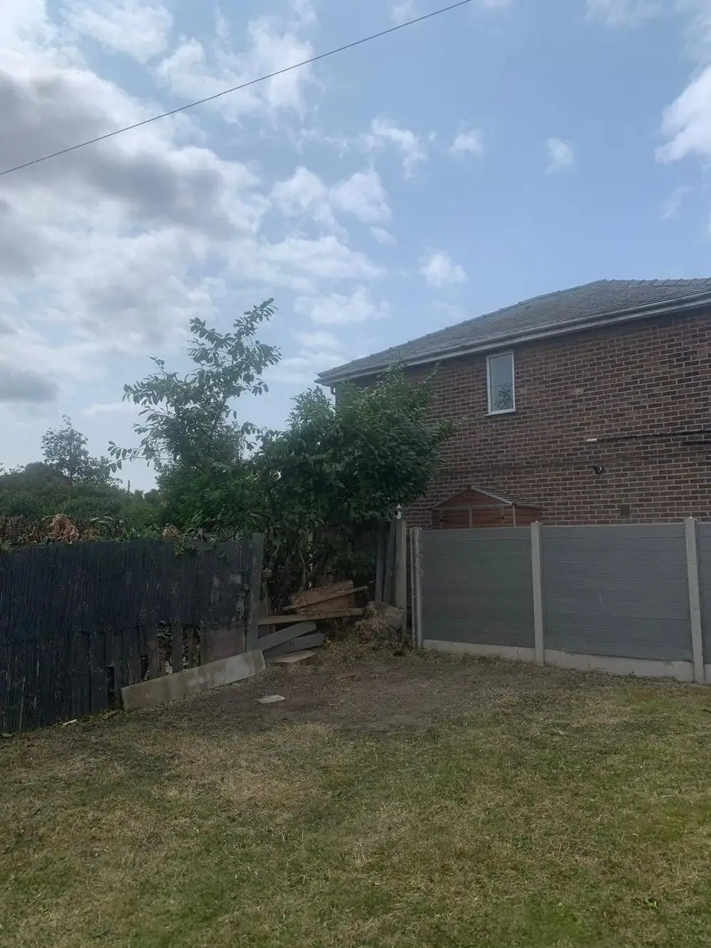 The same garden with the tree taken down and the lawn clear