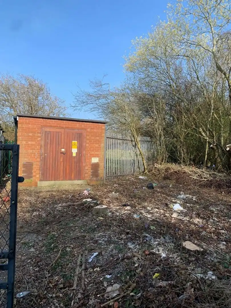 The same brick kiosk with the trees and scrub cleared from around it